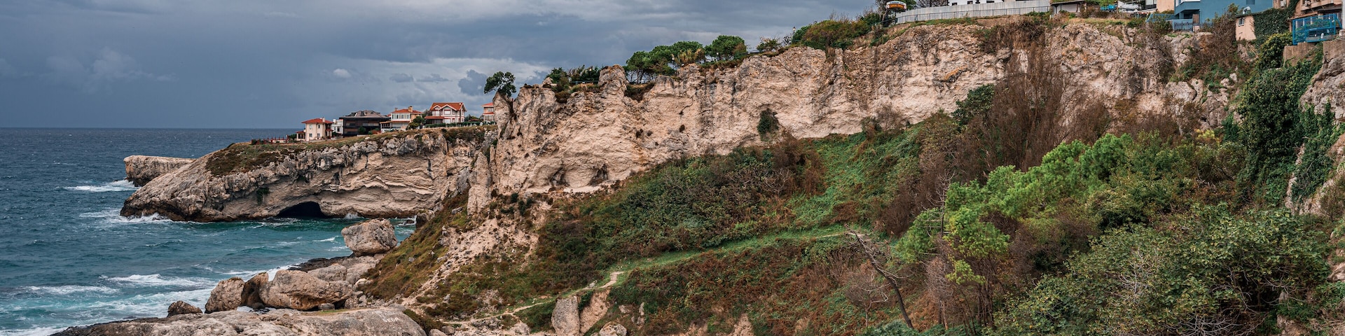 View of lighthouse at seashore against cloudy sky. Beautiful Lighthouse On The Rocks near Sile, Istanbul, Turkey, Black Sea. panorama