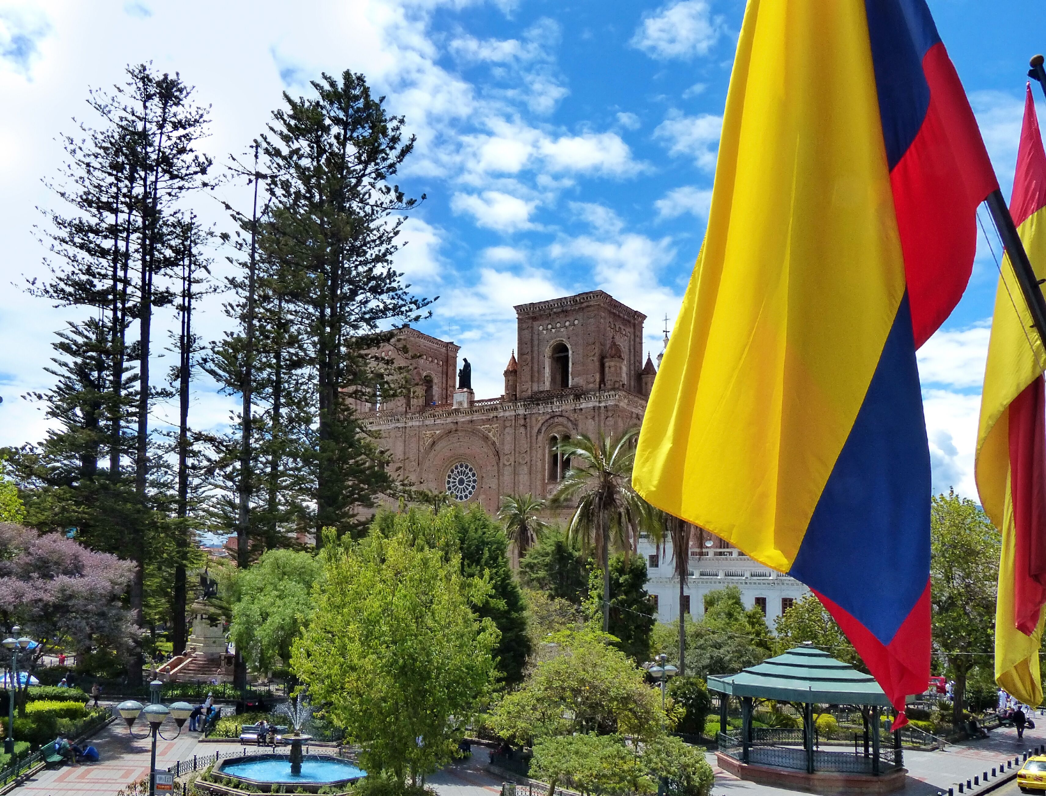 Cuenca, Ecuador. Park Calderon and Inmaculada Concepcion Cathedral with flags waving in front in the  historical center of the city