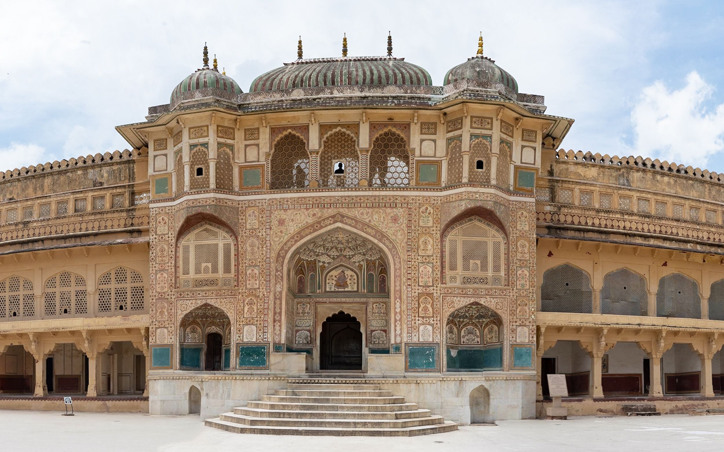 A historic building with intricate architectural details, domes, and arched windows.