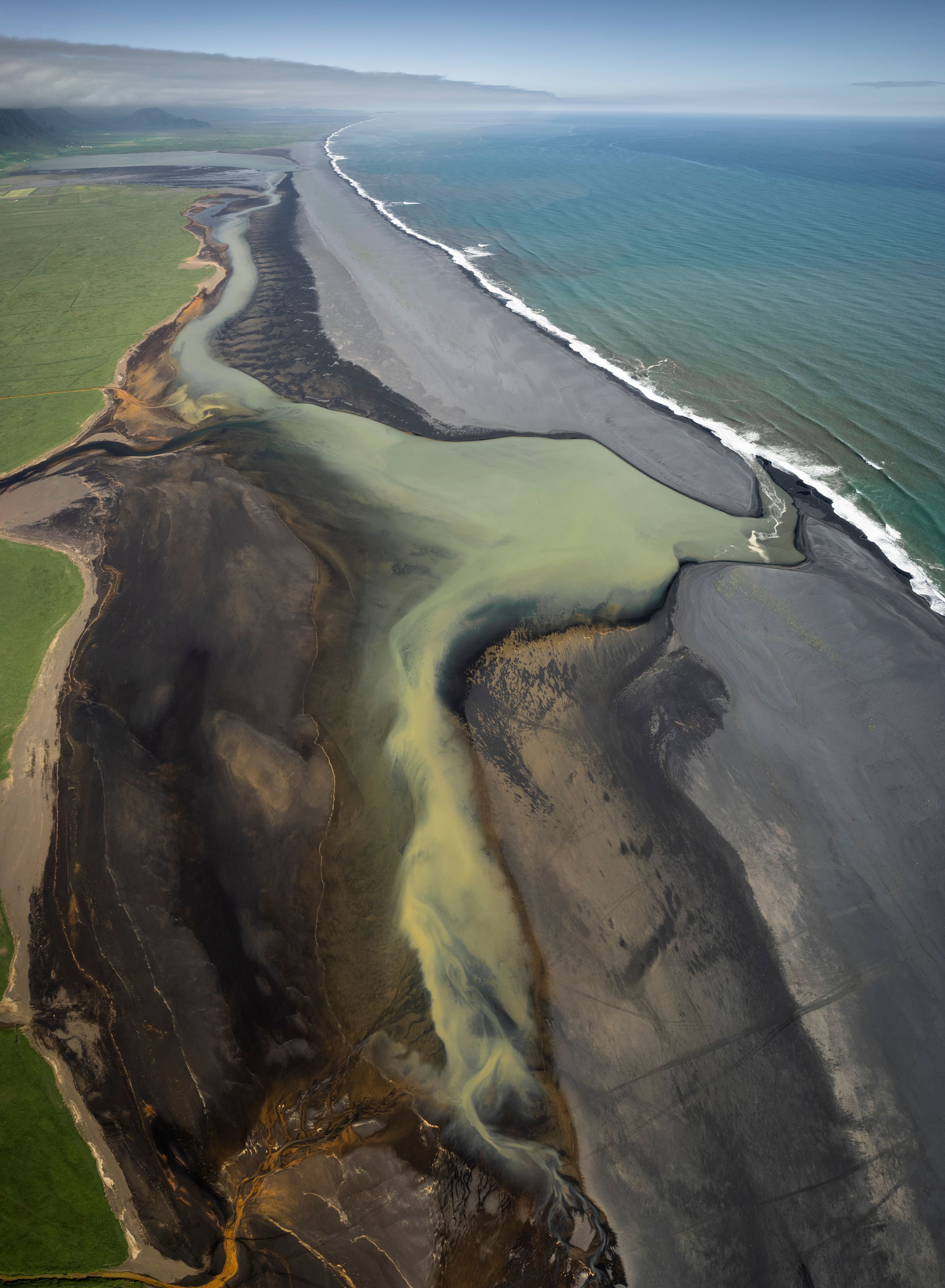 Aerial view of black sand beach with coastline, Holt, Iceland.