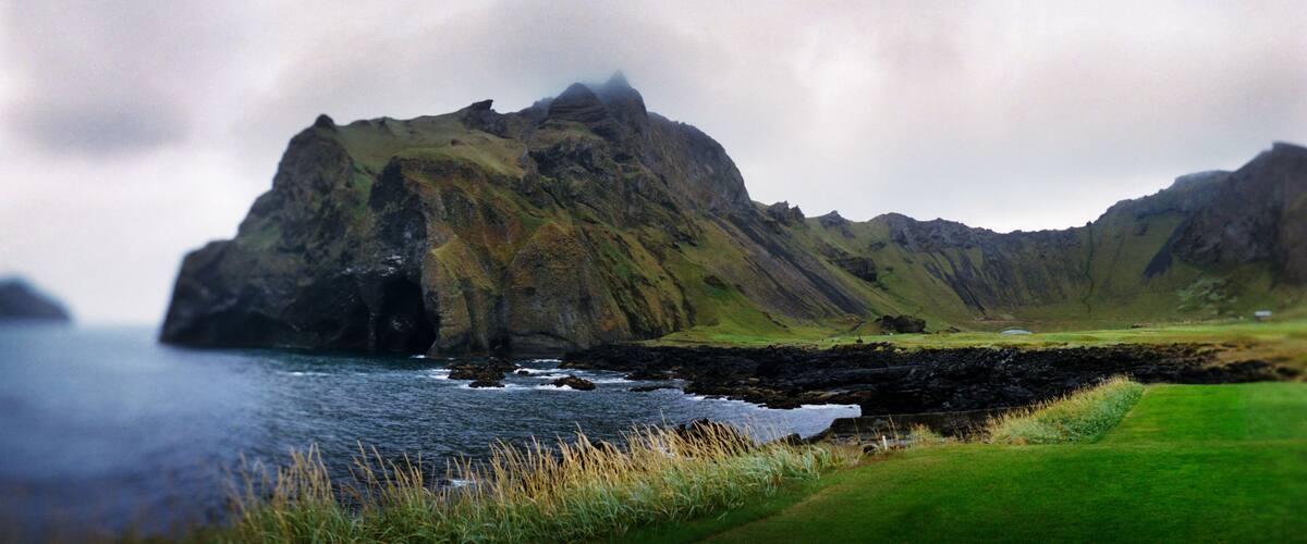 A rugged mountain landscape with a coastal view.