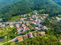 Mulgeon-ri, Namhae-gun, Gyeongsangnam-do, South Korea - June 18, 2023: Aerial and summer view road and of houses with orange roof at German Village on the hill and mountain