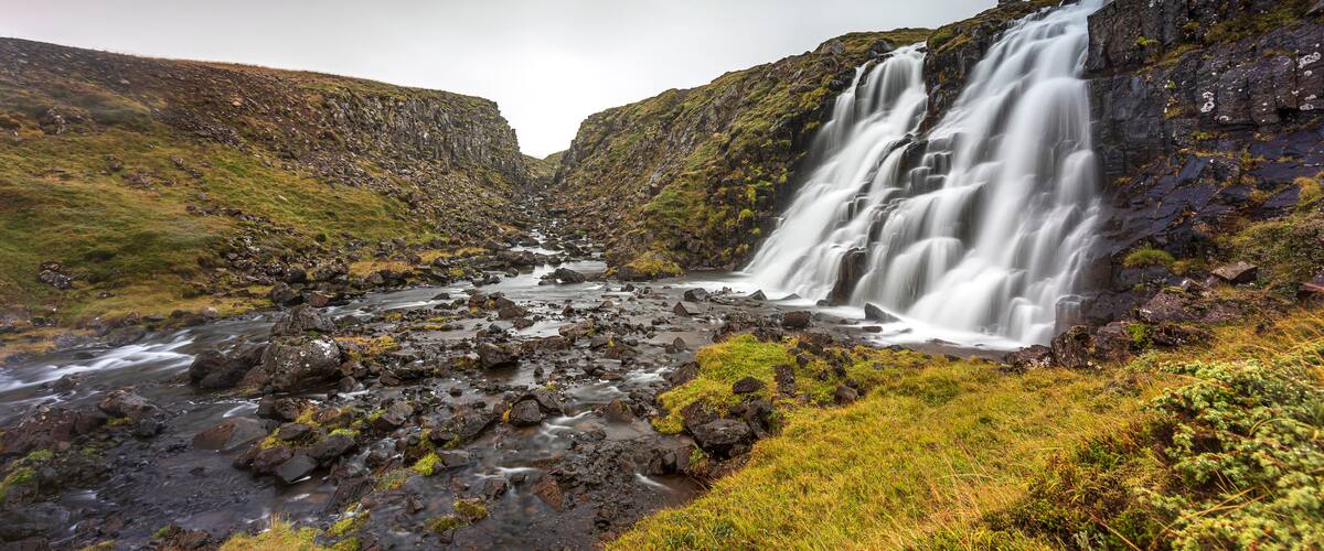 Waterfall cascading into river, Eyja- og Miklaholtshreppur, Vesturland, Iceland