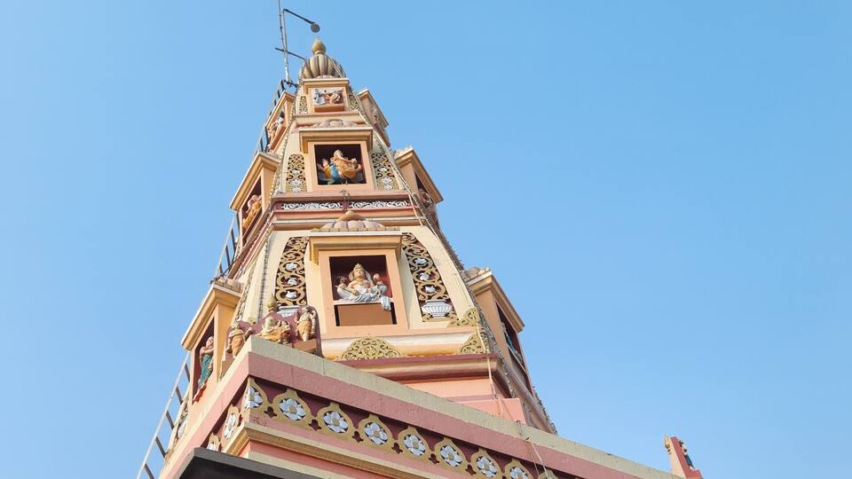 A temple with intricate carvings and a spire.