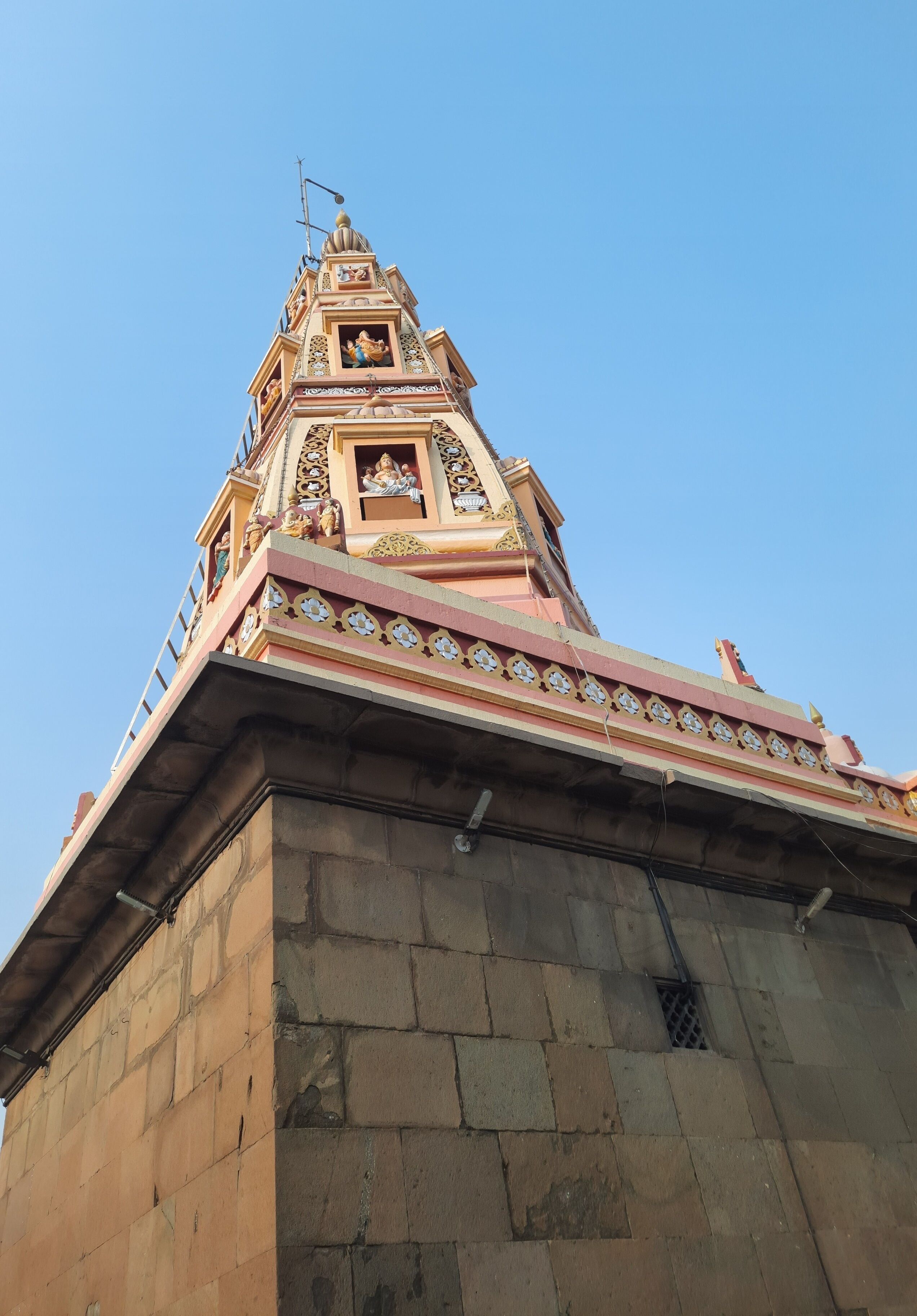 A temple with intricate carvings and a spire.