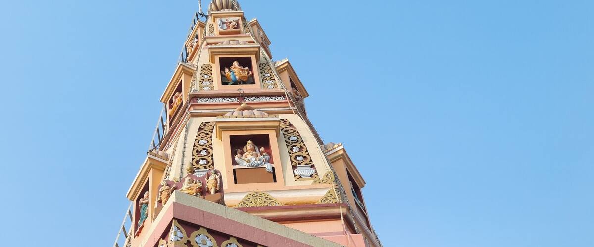 A temple with intricate carvings and a spire.
