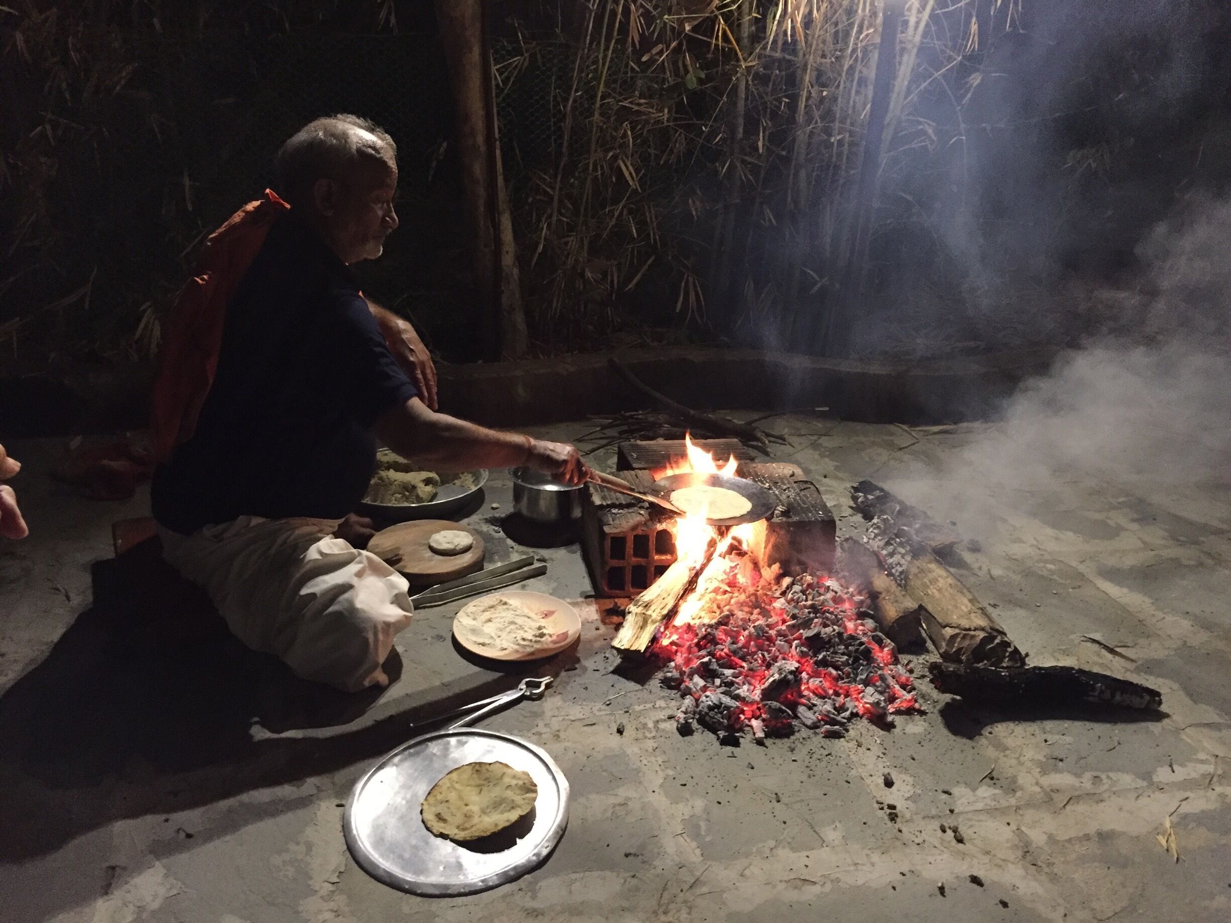 The head cool at Tiger Trails Lodge making rotis over open flame in the courtyard for dinner one night