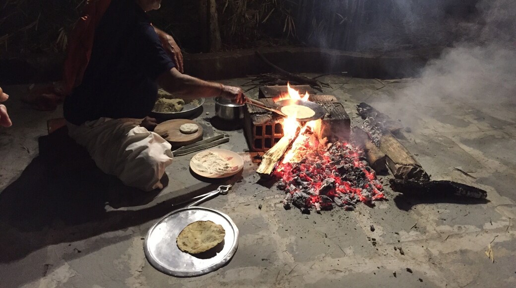 The head cool at Tiger Trails Lodge making rotis over open flame in the courtyard for dinner one night