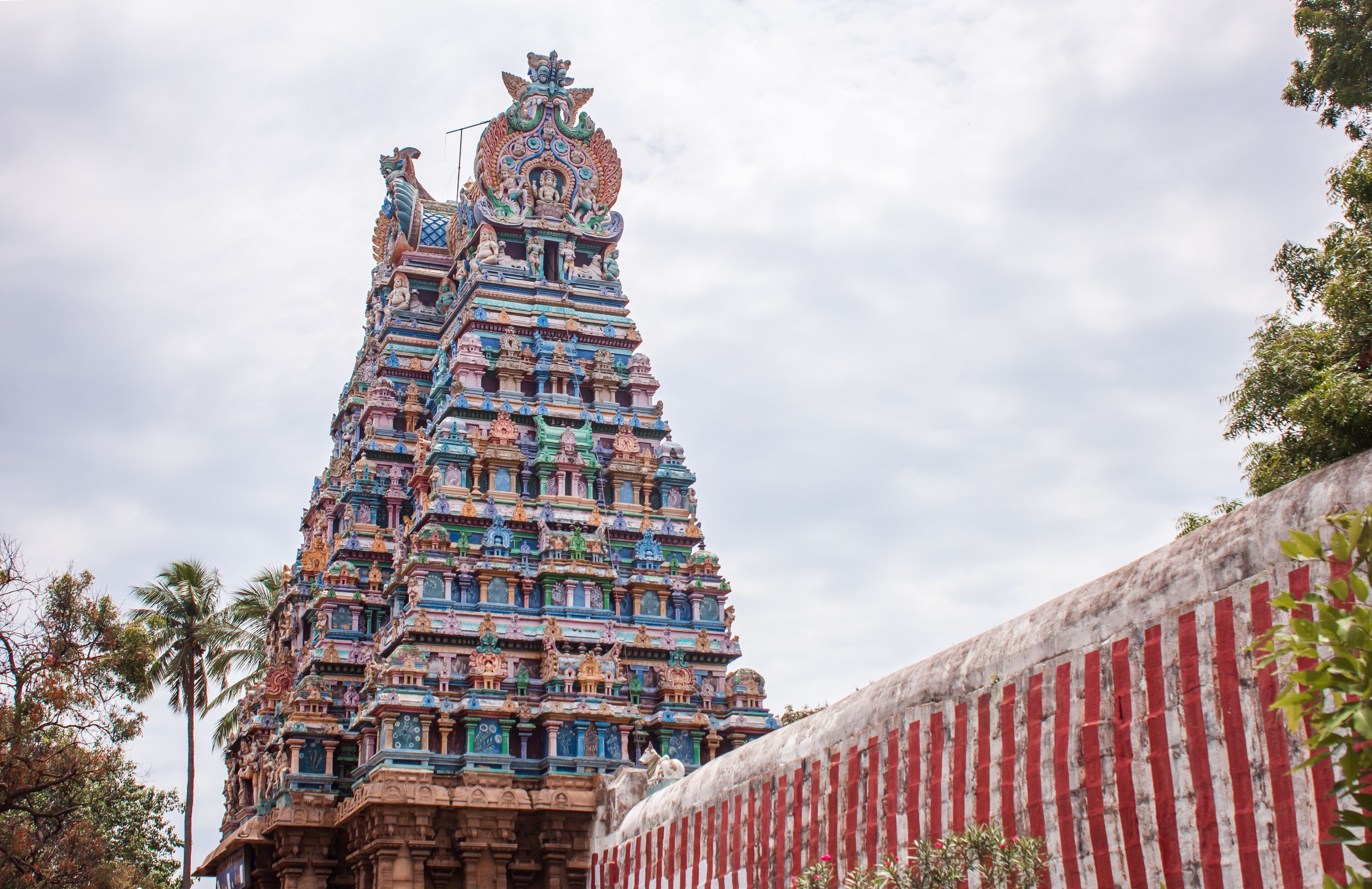 A colorful temple with intricate carvings and a tiered structure.