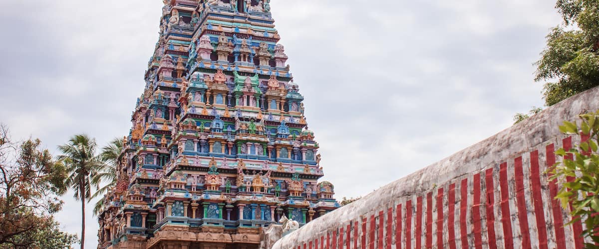 A colorful temple with intricate carvings and a tiered structure.