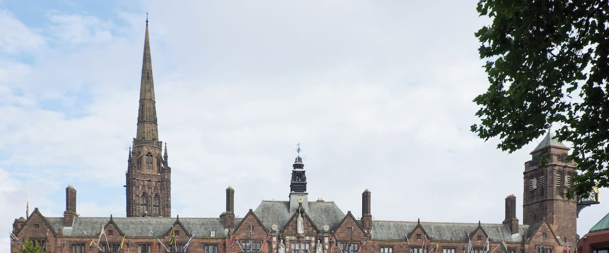 The Council House, Coventry with the 90-metre spire of the war-ruined 14th-century St Michael's Cathedral visible behind. This building, built 1913-17, is a Grade II Listed Building in England.