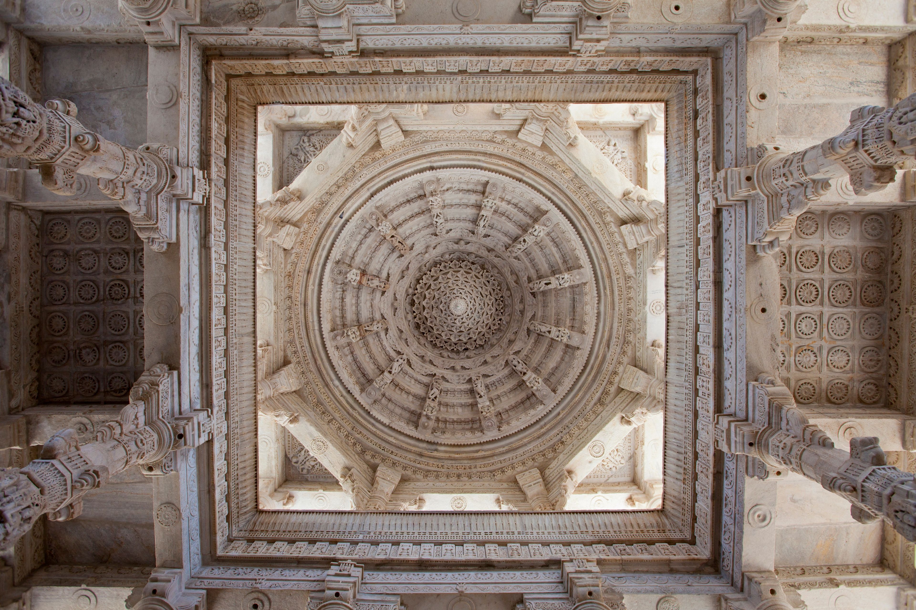 A detailed stone structure with a central circular design surrounded by intricate carvings.