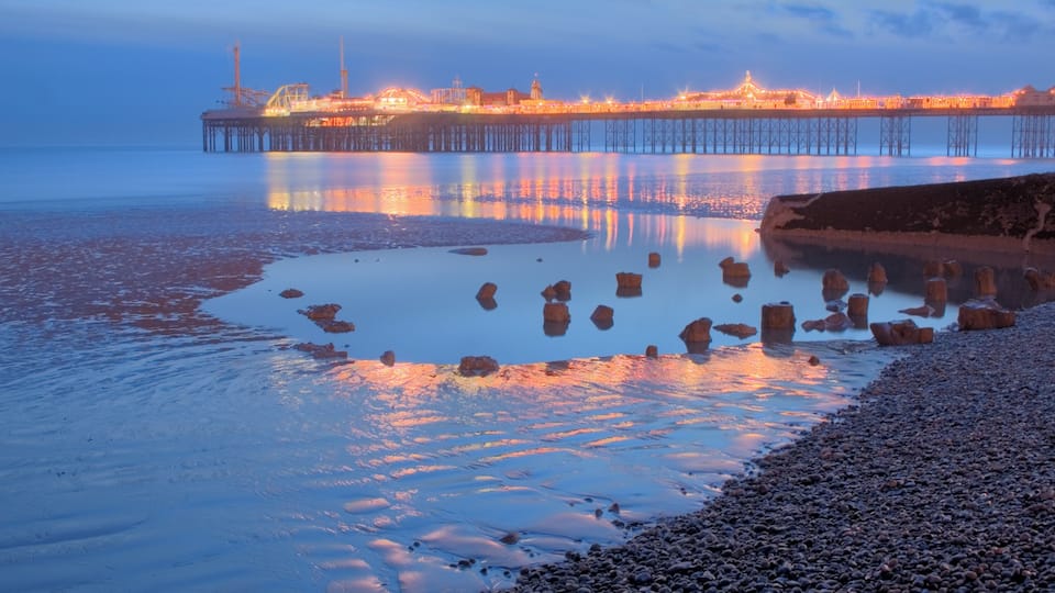 Oak foundation piles of the Royal Suspension Chain Pier Brighton exposed at very low tide in 2010. Some masonry blocks that may be Purbeck stone (a limestone that can be polished like marble) from the promenade can also be seen. In the background Brighton Pier (Brighton Marine Palace and Pier) can be seen. An HDR image resolved using local adaptation.