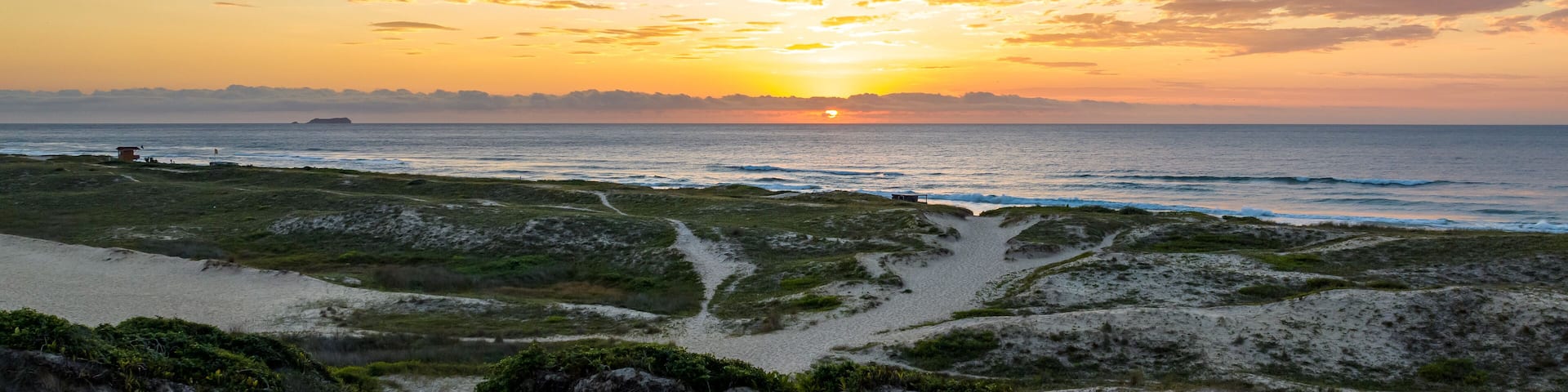 Florianópolis, Campeche beach during sunrise. Brazil. Rio Tavares neighborhood in web banner during sunrise. Aerial view in web banner.