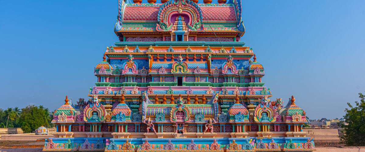 A colorful temple with intricate carvings and multiple tiers.