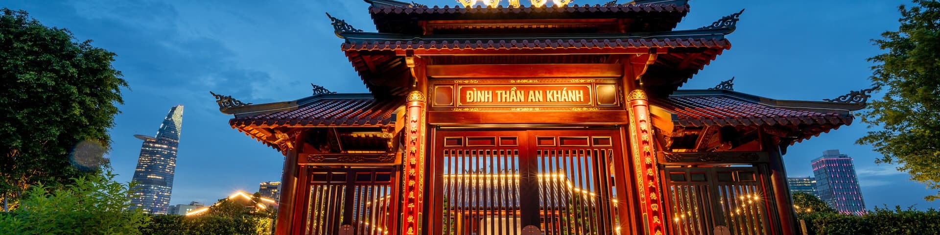 view of An Khanh temple and Ho Chi Minh City skyline. Amazing colorful night view of skyscraper and other modern buildings at downtown. Travel concept