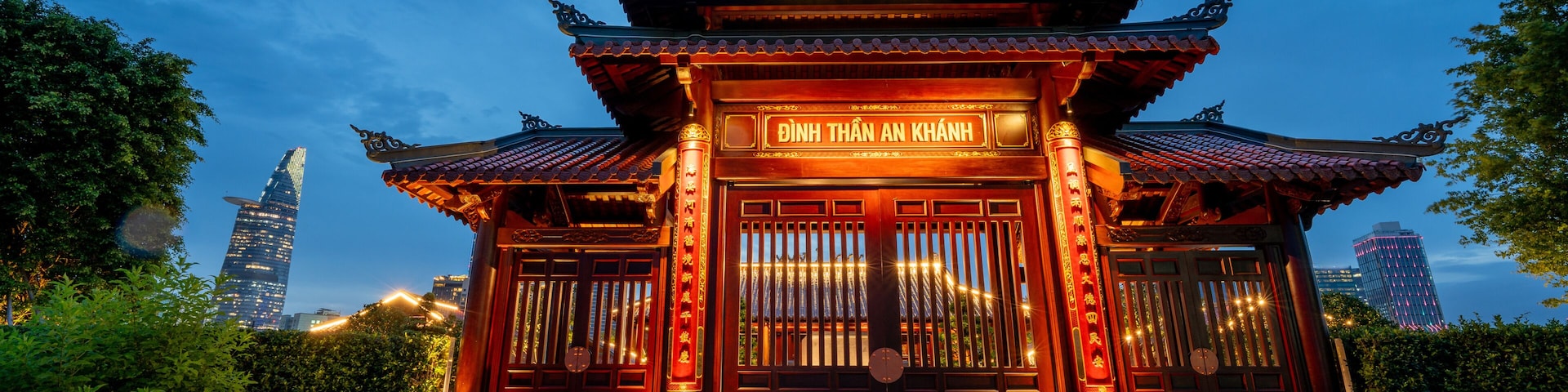 view of An Khanh temple and Ho Chi Minh City skyline. Amazing colorful night view of skyscraper and other modern buildings at downtown. Travel concept