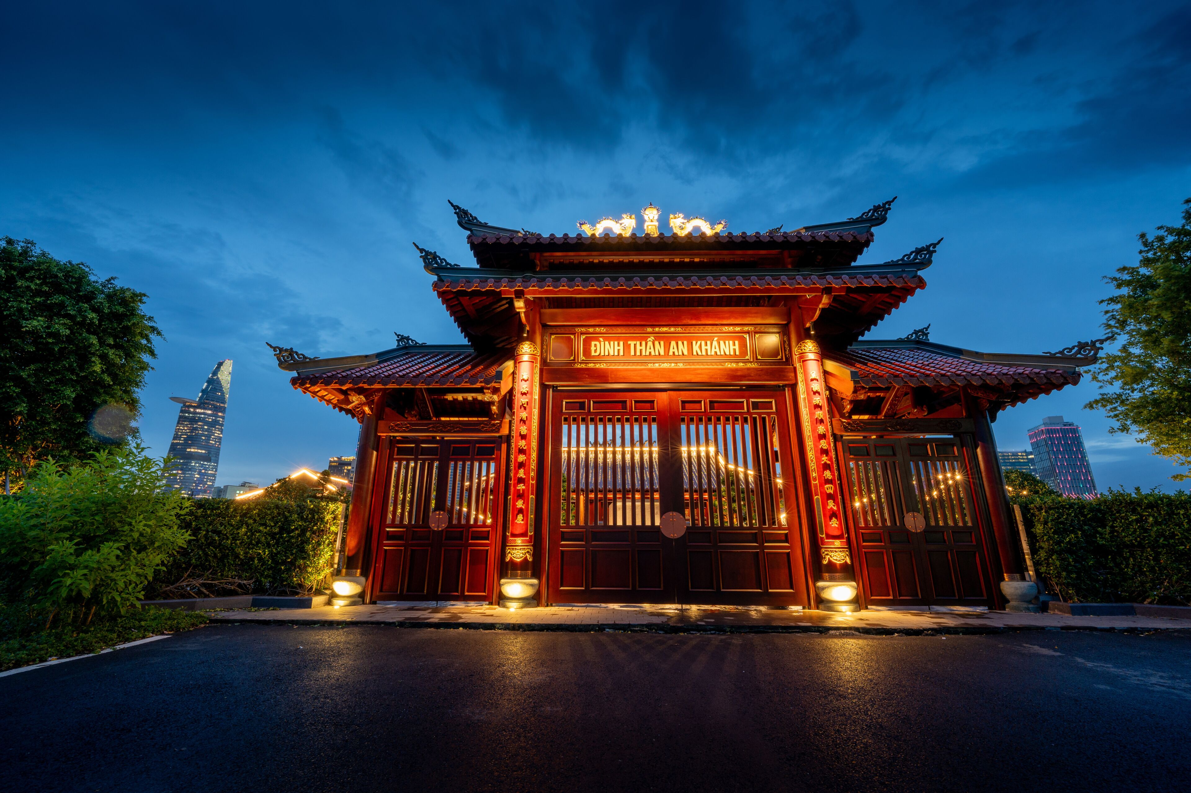 A traditional Chinese gate with ornate decorations and a sign reading 'Dinh Thanh An Khanh'.