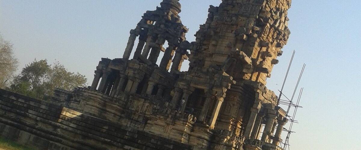 An ancient stone structure with columns and a large stone pillar.