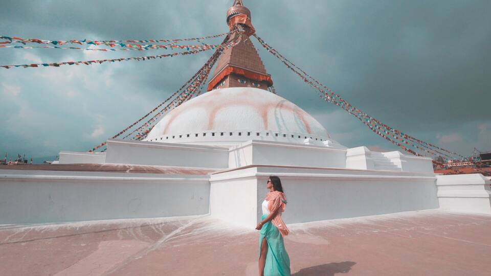 Woman walking beside Boudha stupa