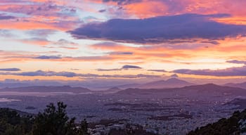 Aerial view of Athens from Hymettus mountain during sunset. In the background the port of Pireaus.