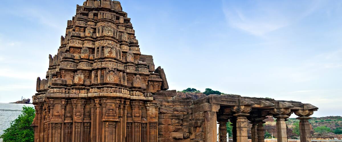 An ancient temple with intricate carvings and a large central tower.