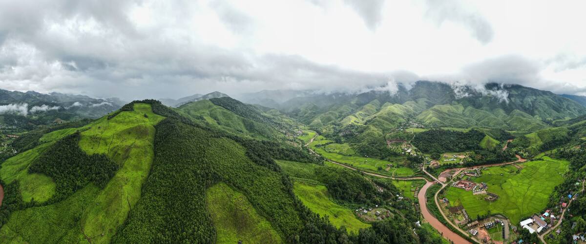 Aerial drone shot, mountain peaks spectacular landscape Rainforest many trees fresh green at Sapan village, Nan Province, Northern Thailand..
