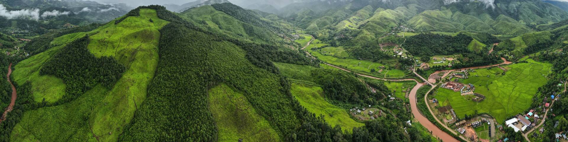 Aerial drone shot, mountain peaks spectacular landscape Rainforest many trees fresh green at Sapan village, Nan Province, Northern Thailand..