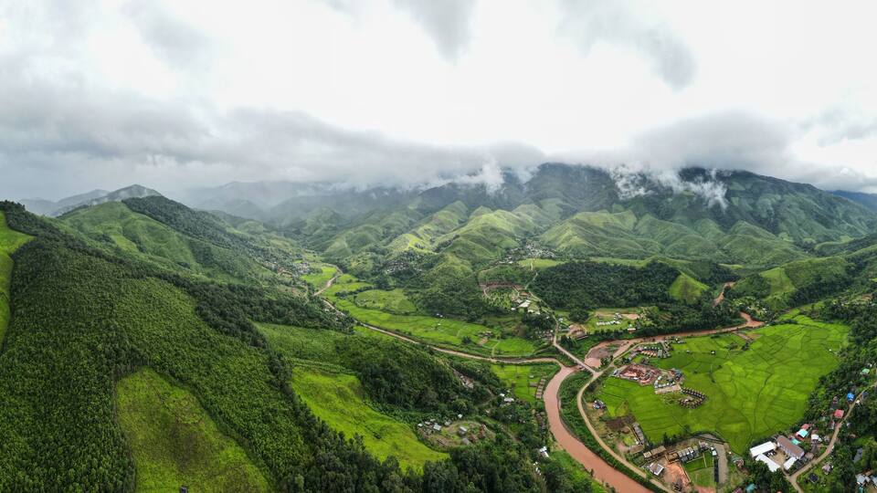 Aerial drone shot, mountain peaks spectacular landscape Rainforest many trees fresh green at Sapan village, Nan Province, Northern Thailand..
