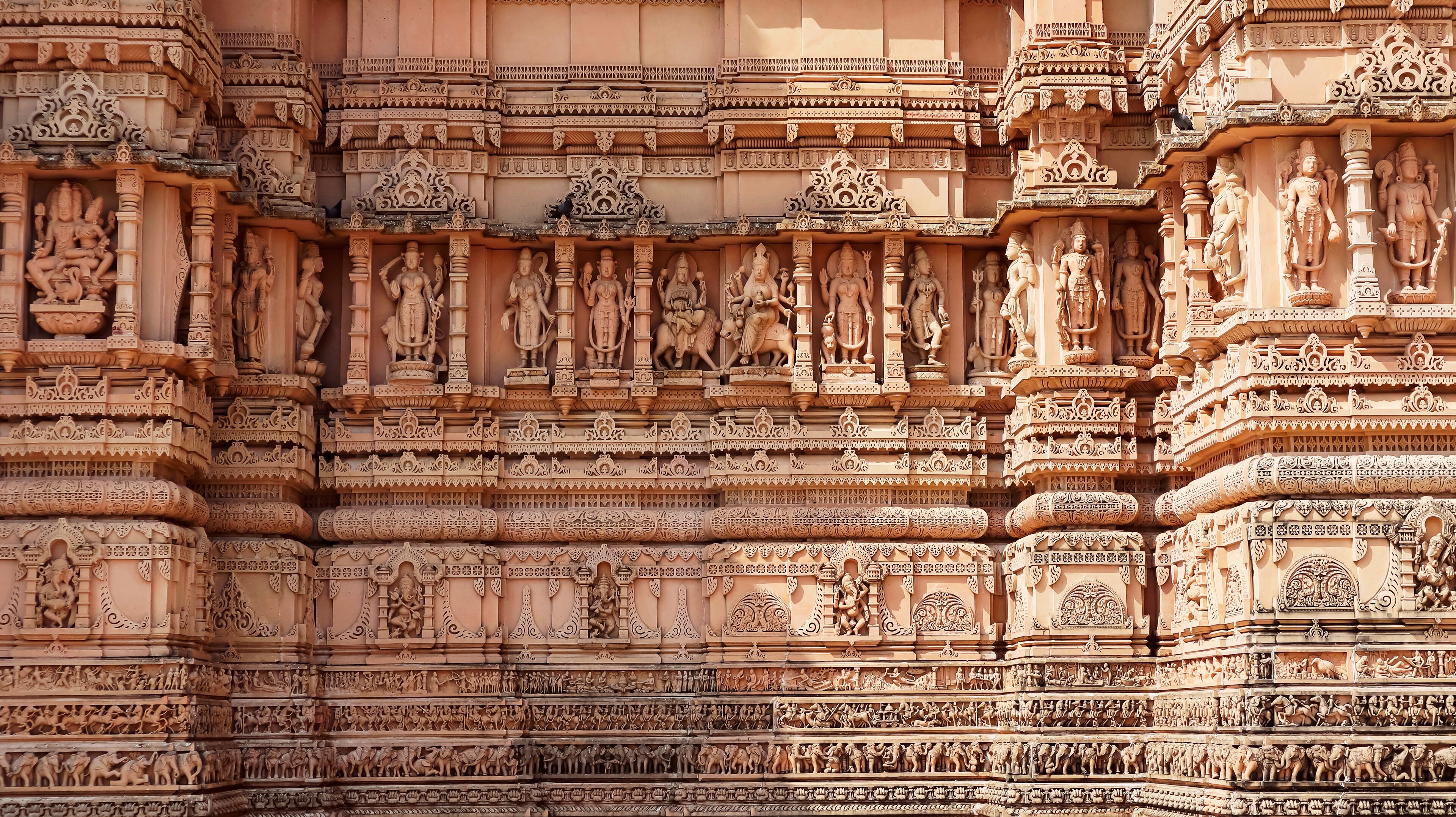 A detailed temple facade with intricate carvings and statues.