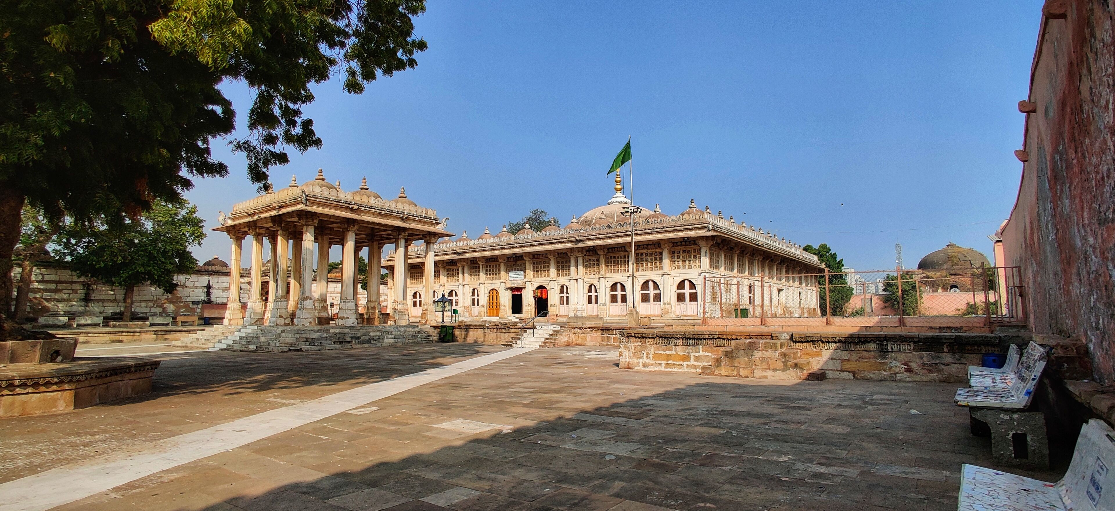 A historic building with a large dome and a flagpole.