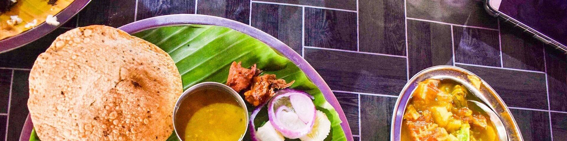 A sumptuous Assamese Thali served on Brass metal plate and easily feed a vegan sans the fish curry in accompanying bowl. Priced at inr 200 I believe.