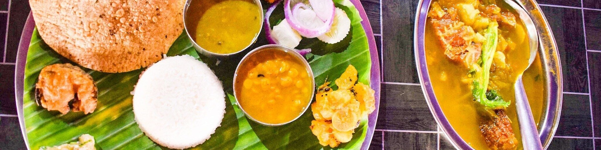 A sumptuous Assamese Thali served on Brass metal plate and easily feed a vegan sans the fish curry in accompanying bowl. Priced at inr 200 I believe.