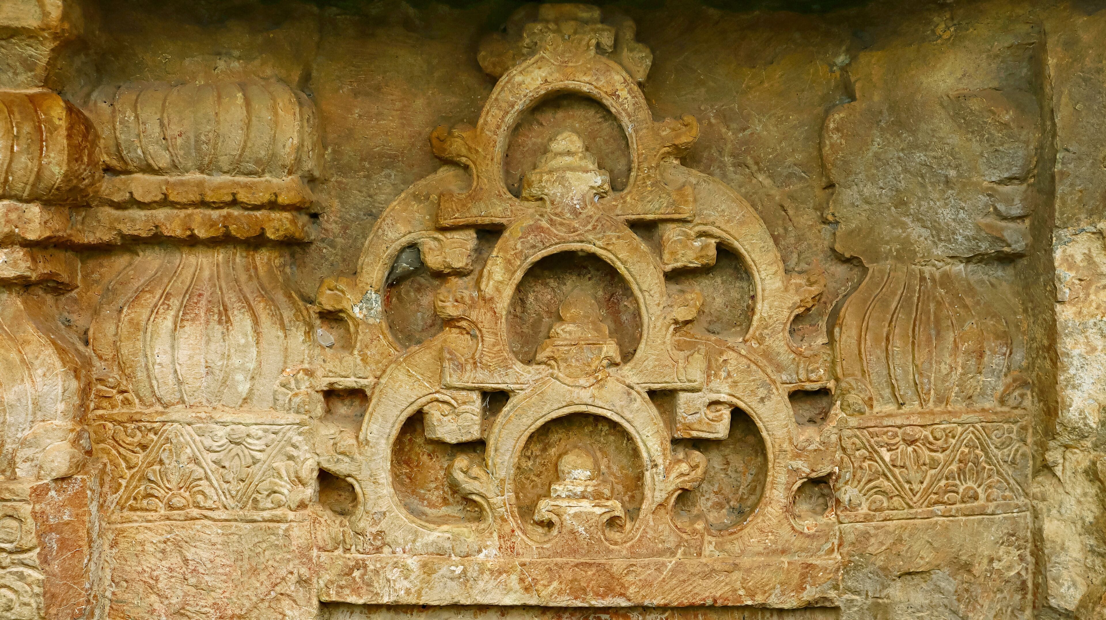 An intricately carved stone structure with symmetrical patterns and detailed artwork.