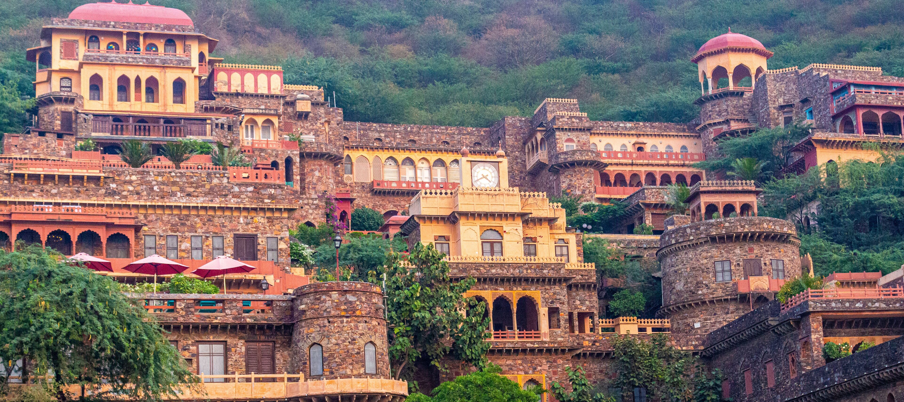 A historic hilltop town with traditional architecture, including domed structures and arched windows.