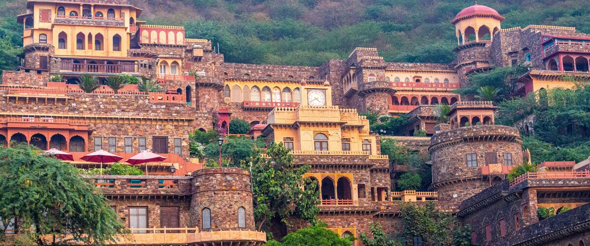 A historic hilltop town with traditional architecture, including domed structures and arched windows.