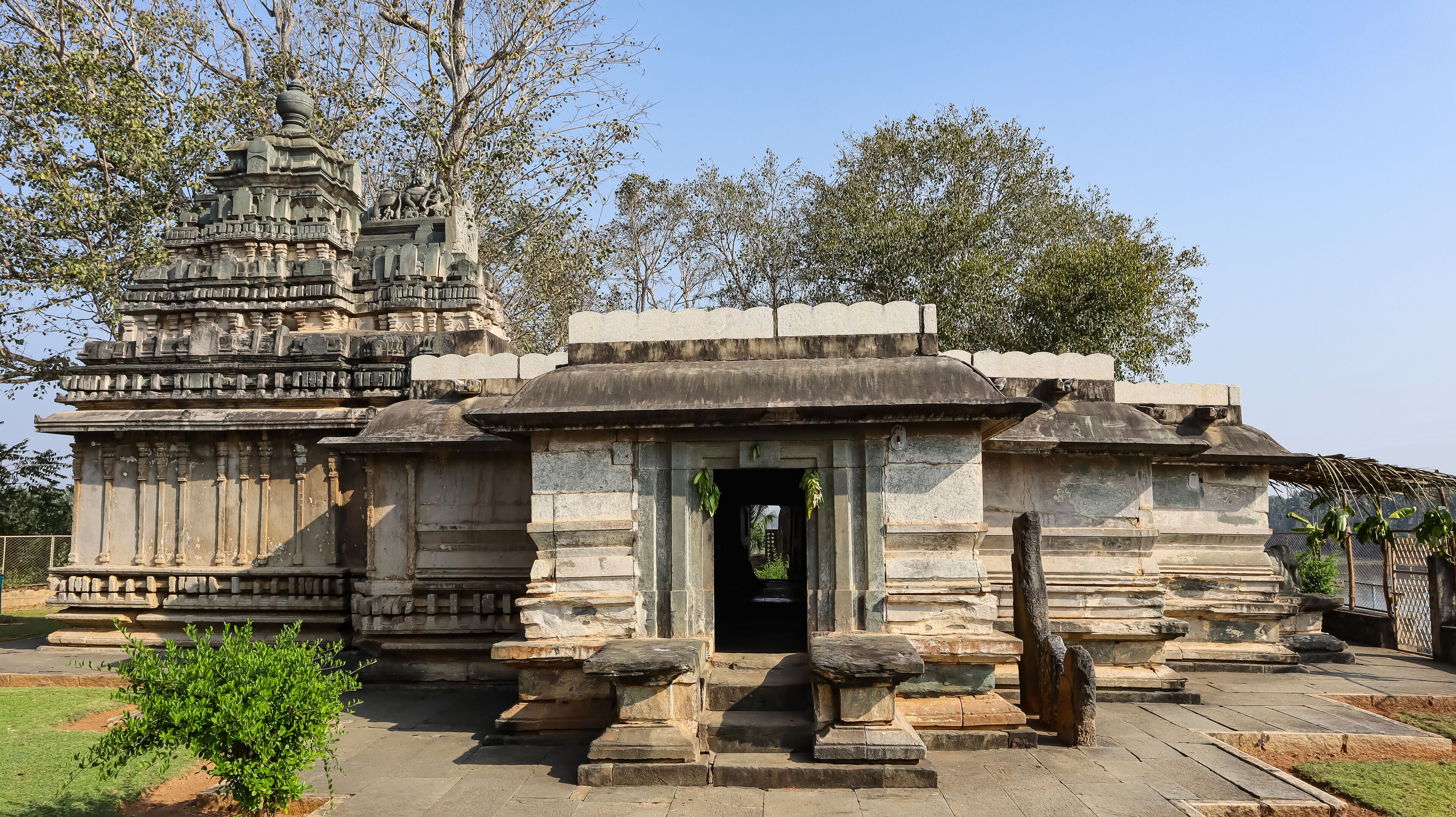 A stone temple with intricate carvings and a central doorway.