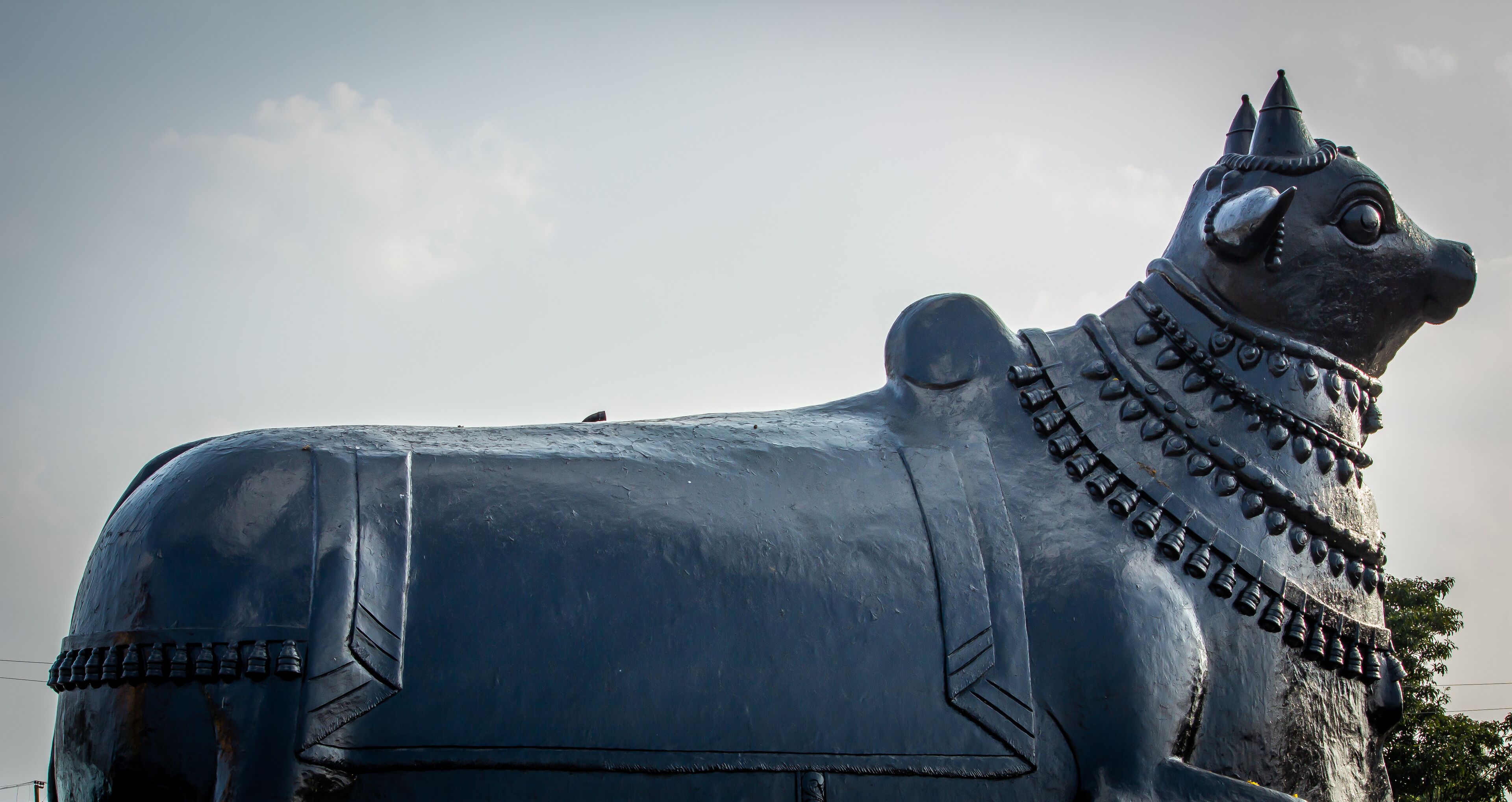 A large metal sculpture of a bull with intricate designs and patterns.