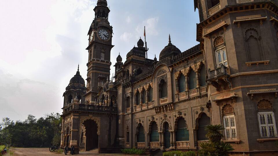 A historic building with intricate architecture, including domes and arches, and a prominent clock tower.