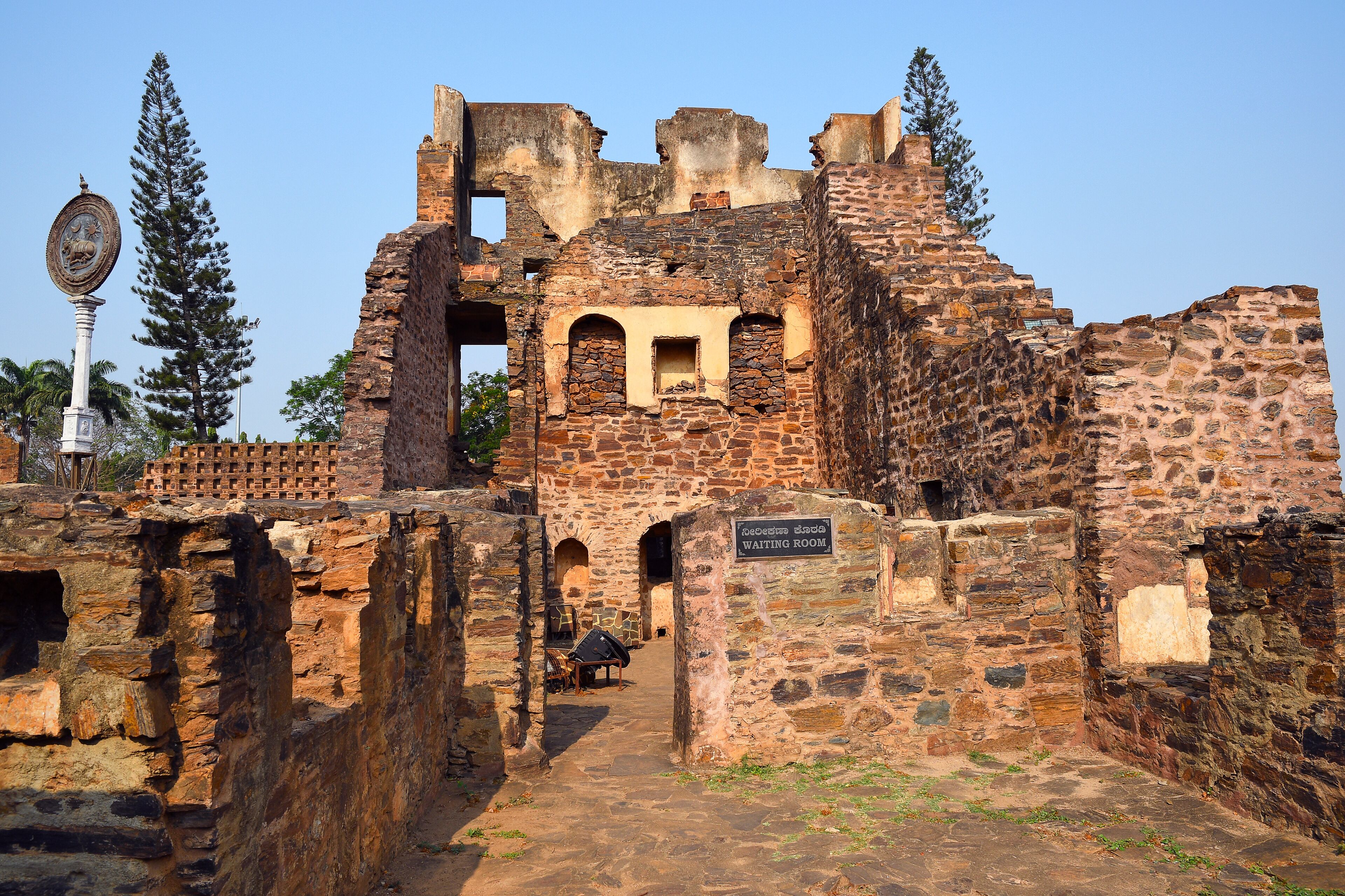 An ancient stone structure with a sign reading "Waiting Room".
