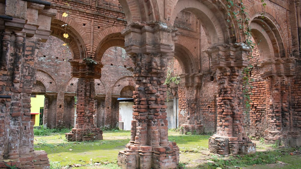 close up view of arched pillars and intricate brick architecture inside the ruins of "tamluk rajbari" palace in west bengal, india