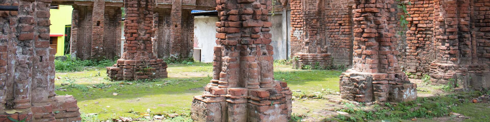 close up view of arched pillars and intricate brick architecture inside the ruins of "tamluk rajbari" palace in west bengal, india