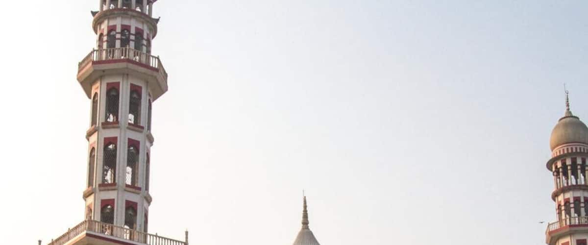 A grand mosque with a large central dome, minarets, and intricate arches.