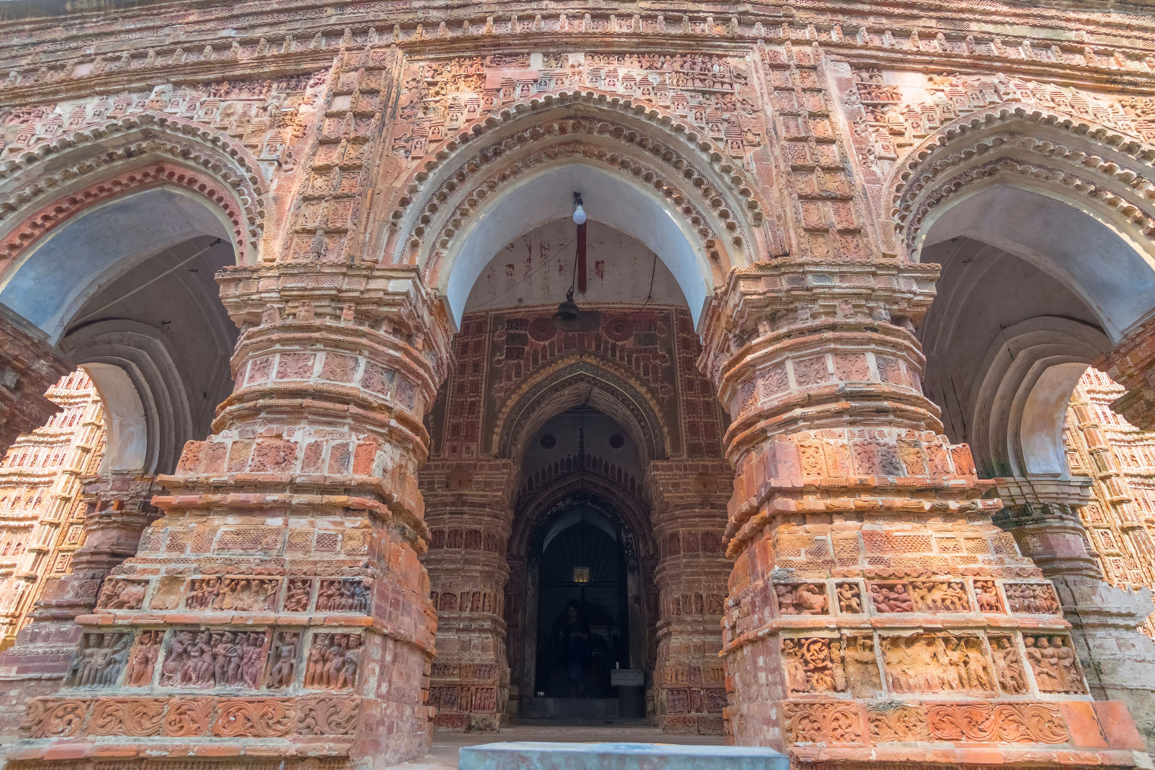 A detailed entrance with intricate carvings and multiple arches.