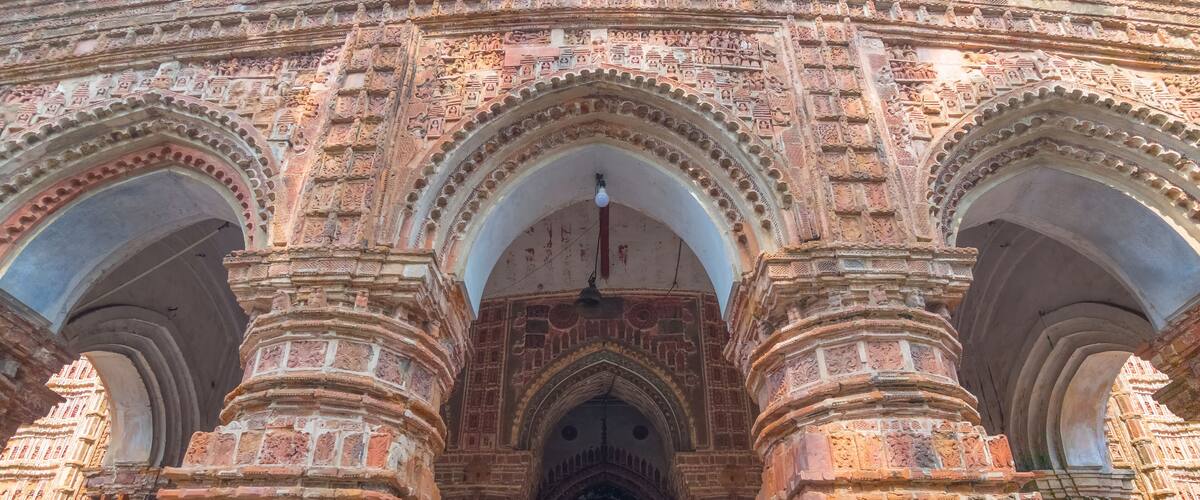 A detailed entrance with intricate carvings and multiple arches.