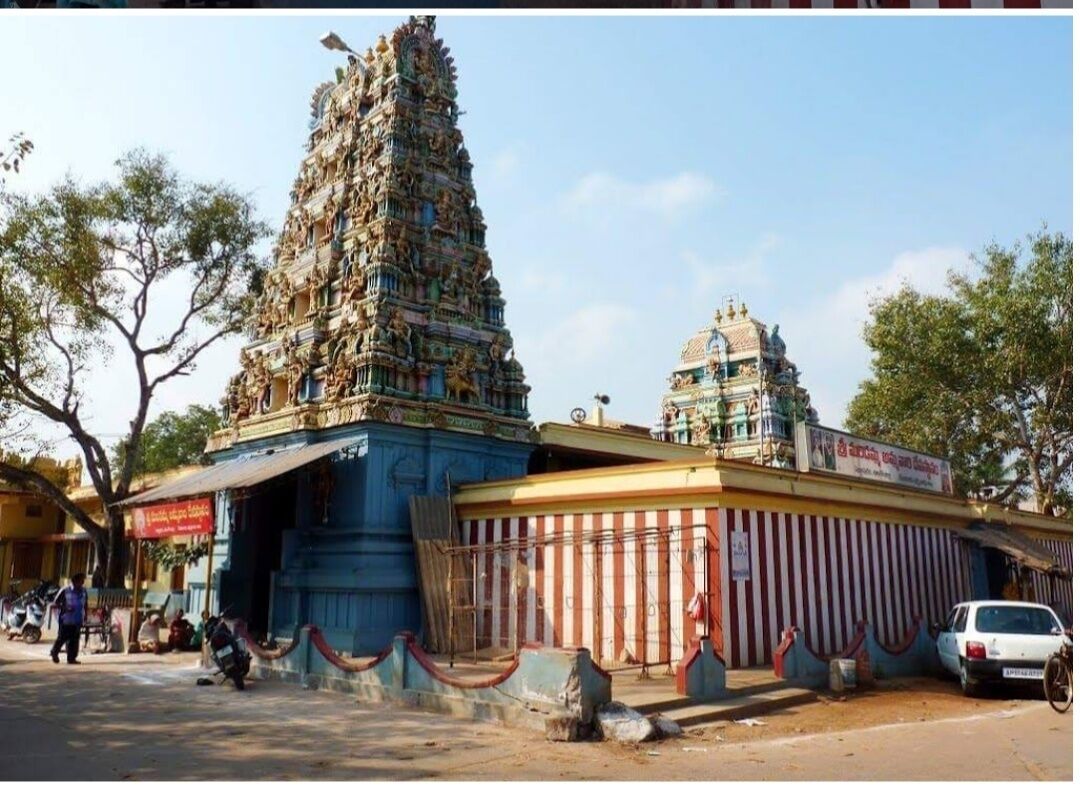 A temple with a tall, ornate tower and a smaller shrine.