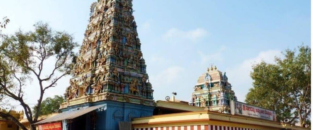 A temple with a tall, ornate tower and a smaller shrine.