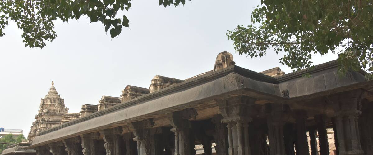 An ancient temple with intricate carvings and a large central dome.