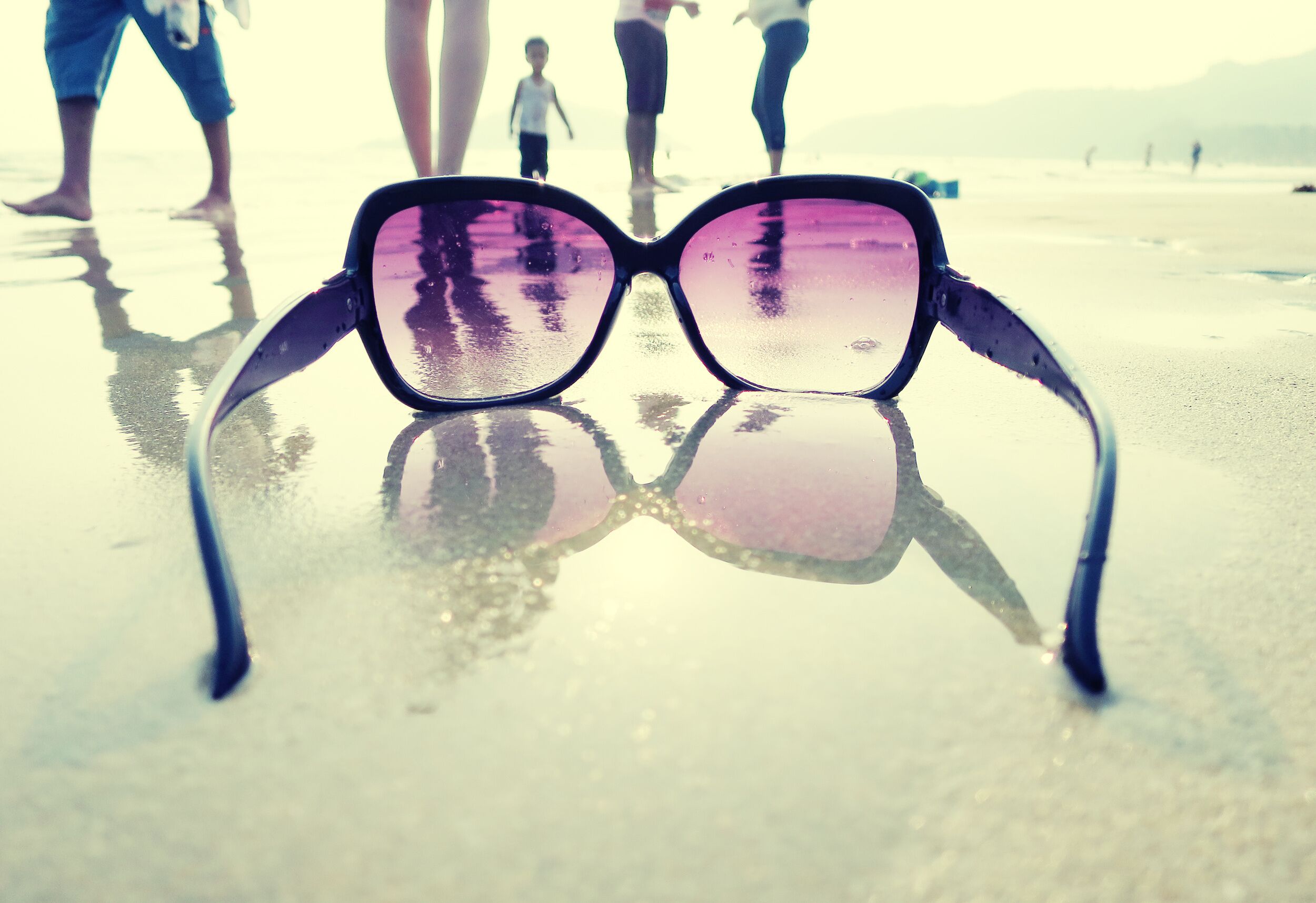 Sunglasses on the sand of Palolem beach. South Goa, India