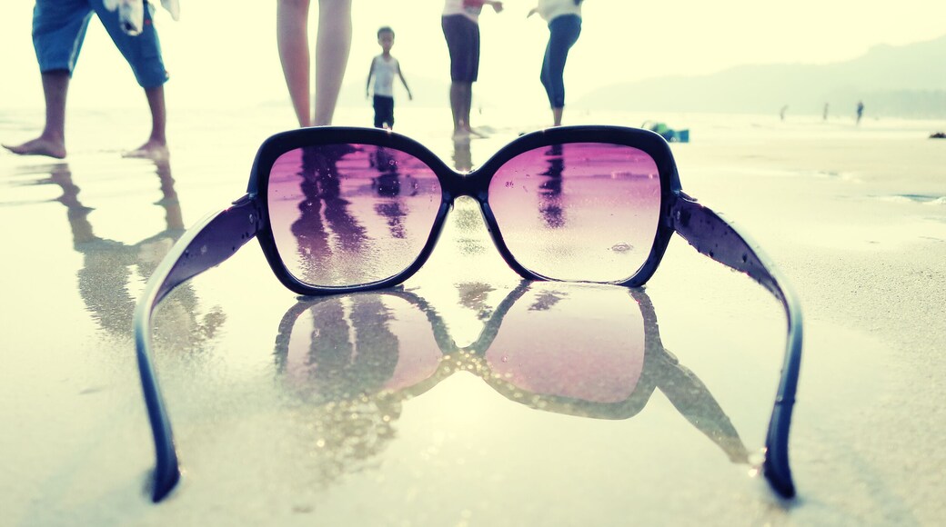 Sunglasses on the sand of Palolem beach. South Goa, India